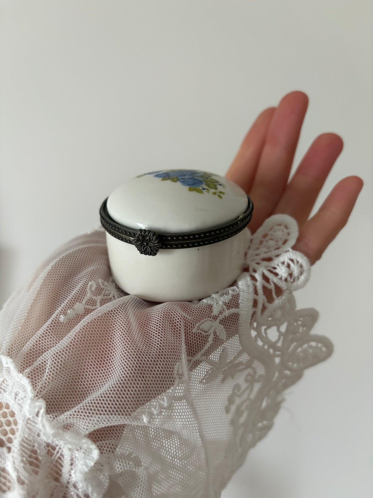 Round porcelain trinket box with blue roses