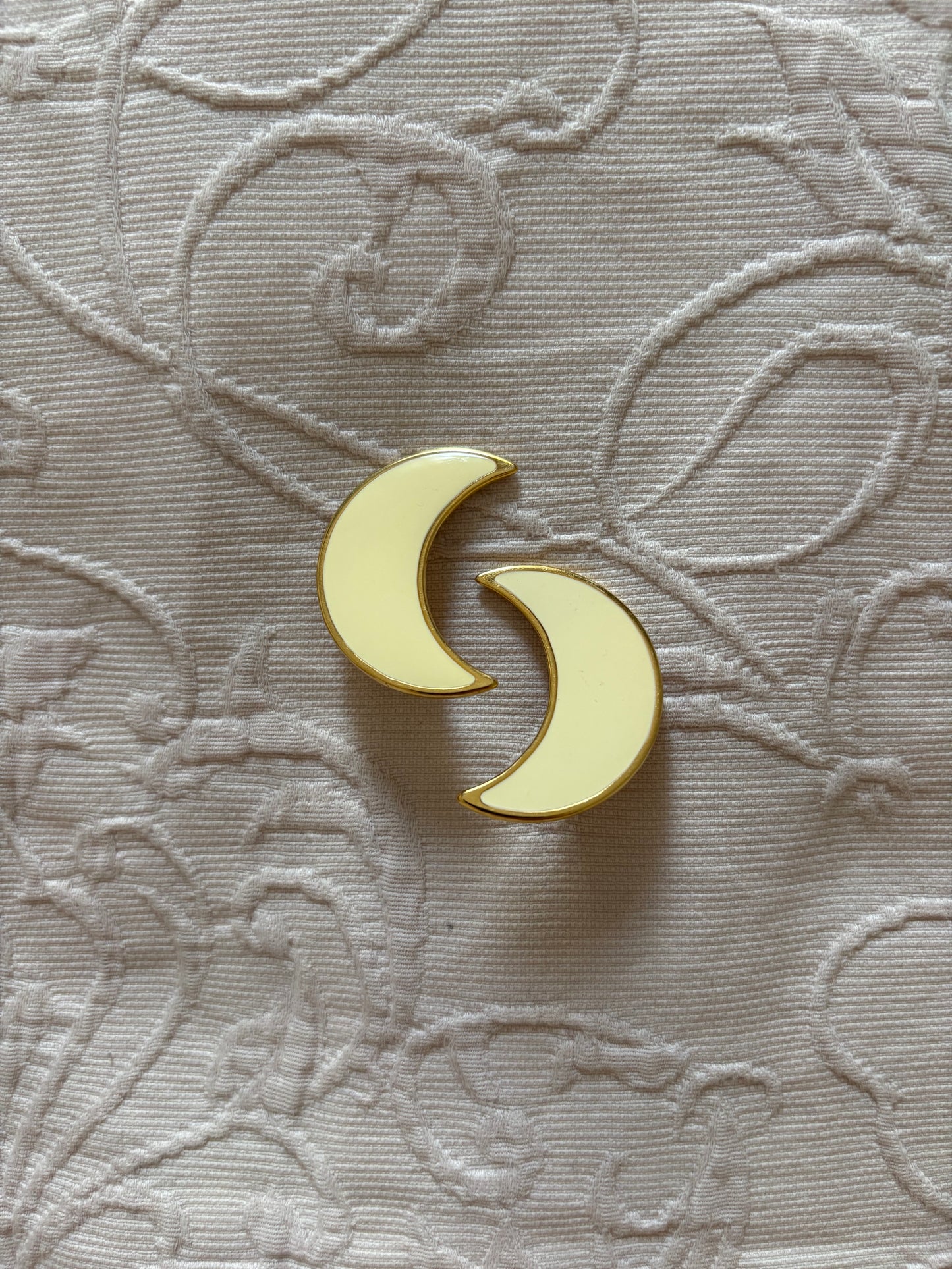 Clip-on earrings with milky enamel in the shape of a large moon