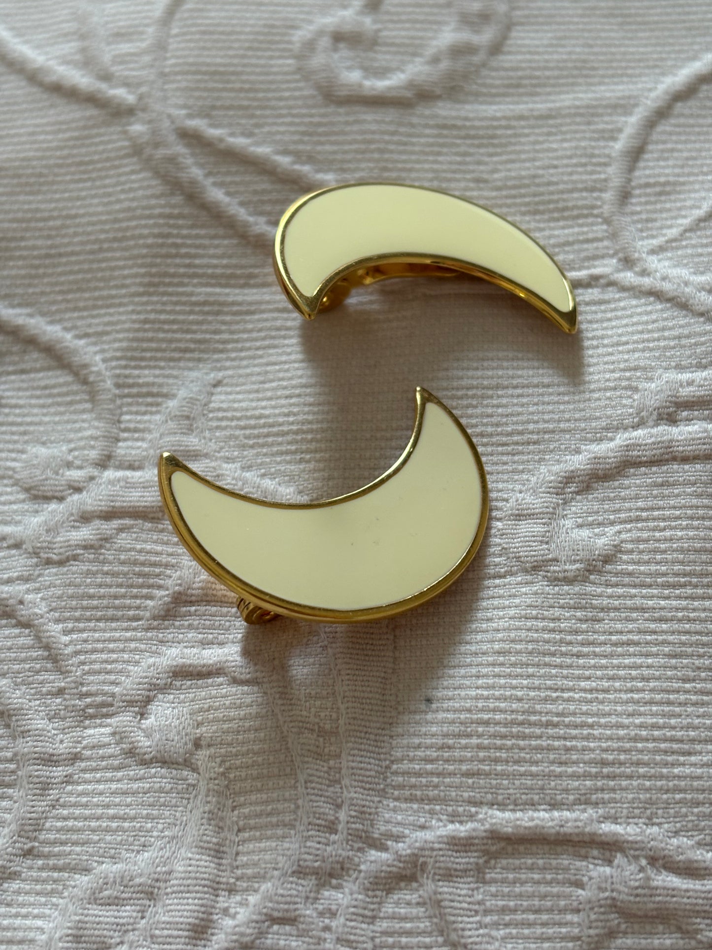 Clip-on earrings with milky enamel in the shape of a large moon