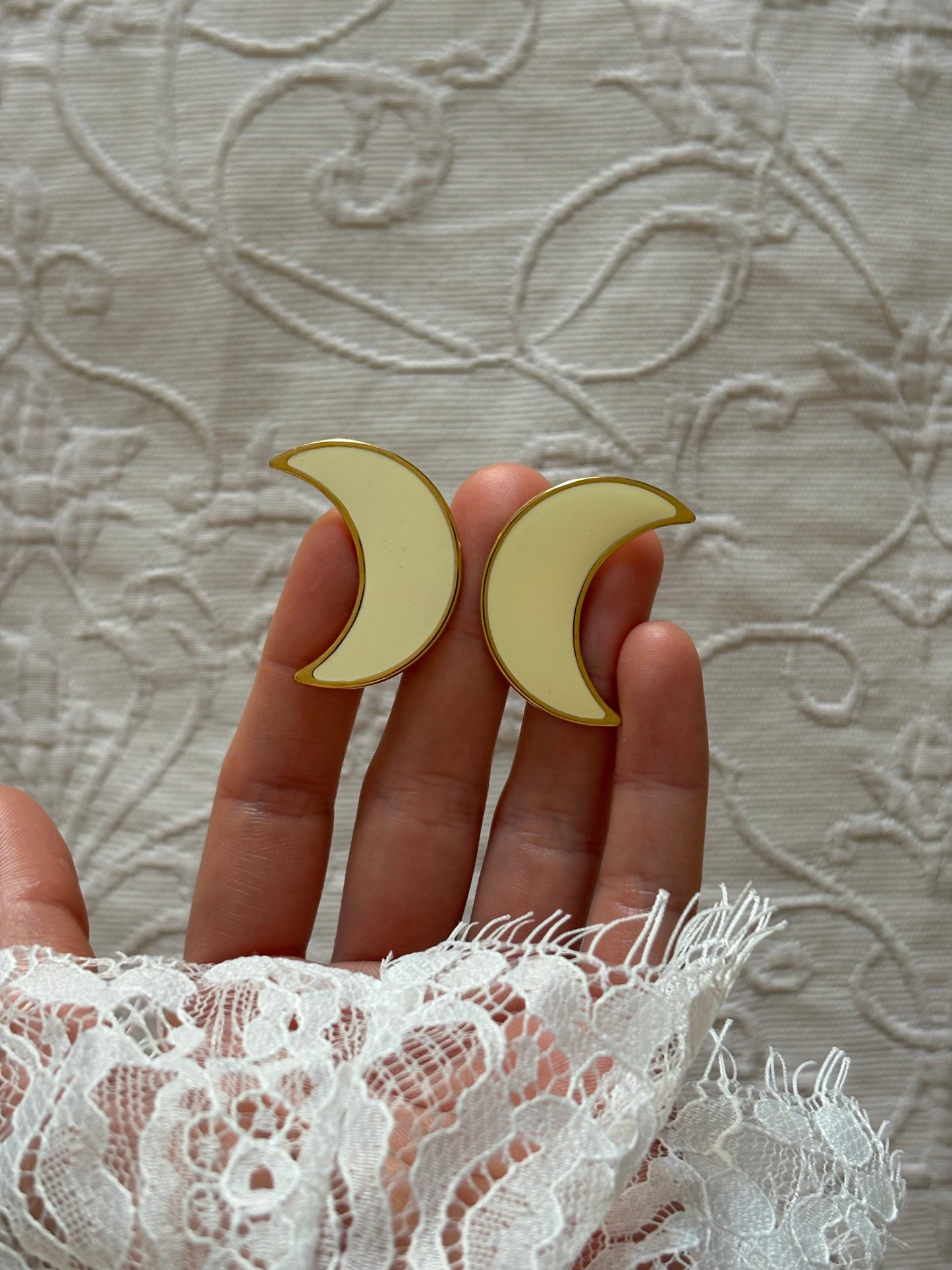 Clip-on earrings with milky enamel in the shape of a large moon