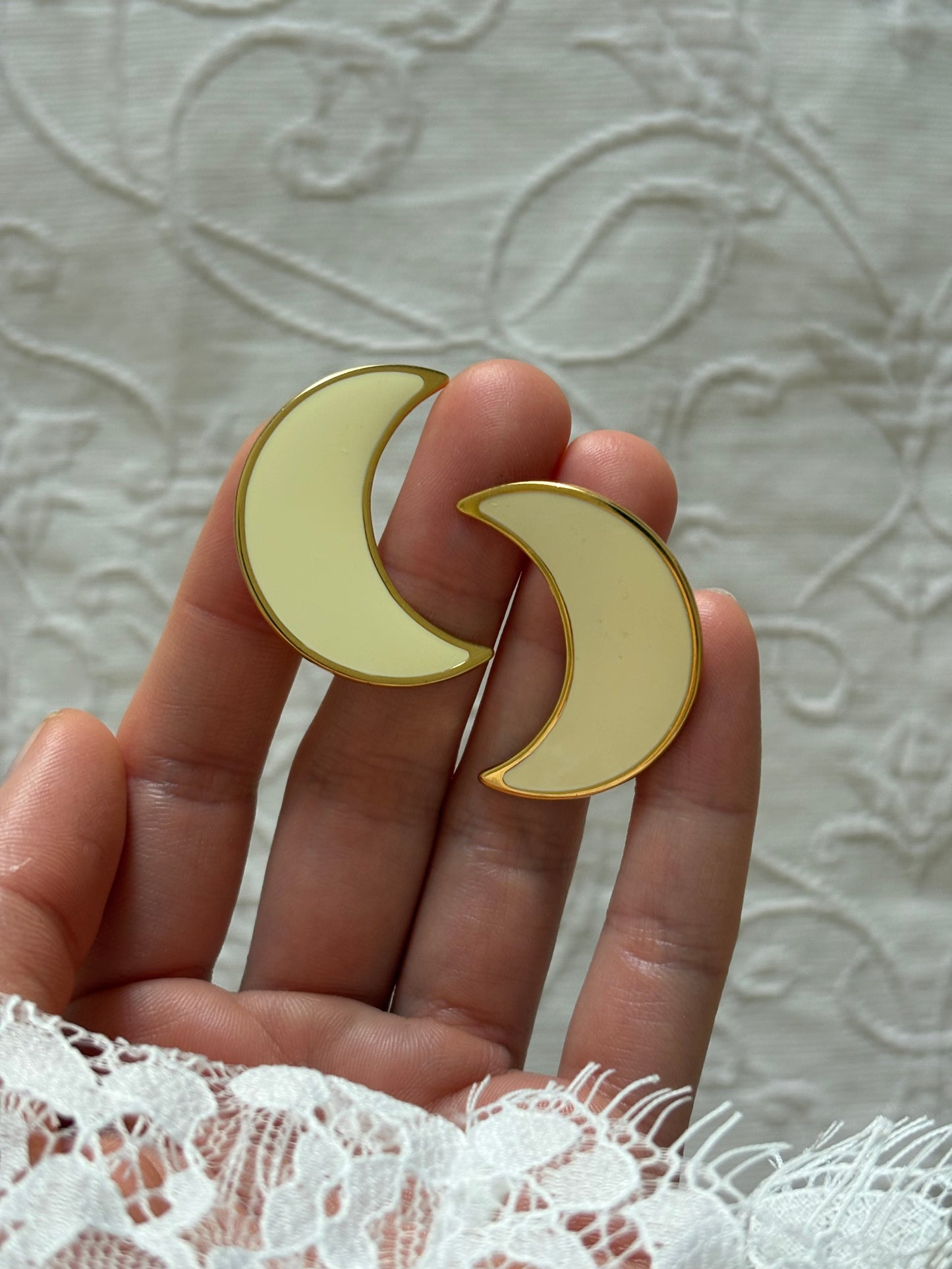 Clip-on earrings with milky enamel in the shape of a large moon