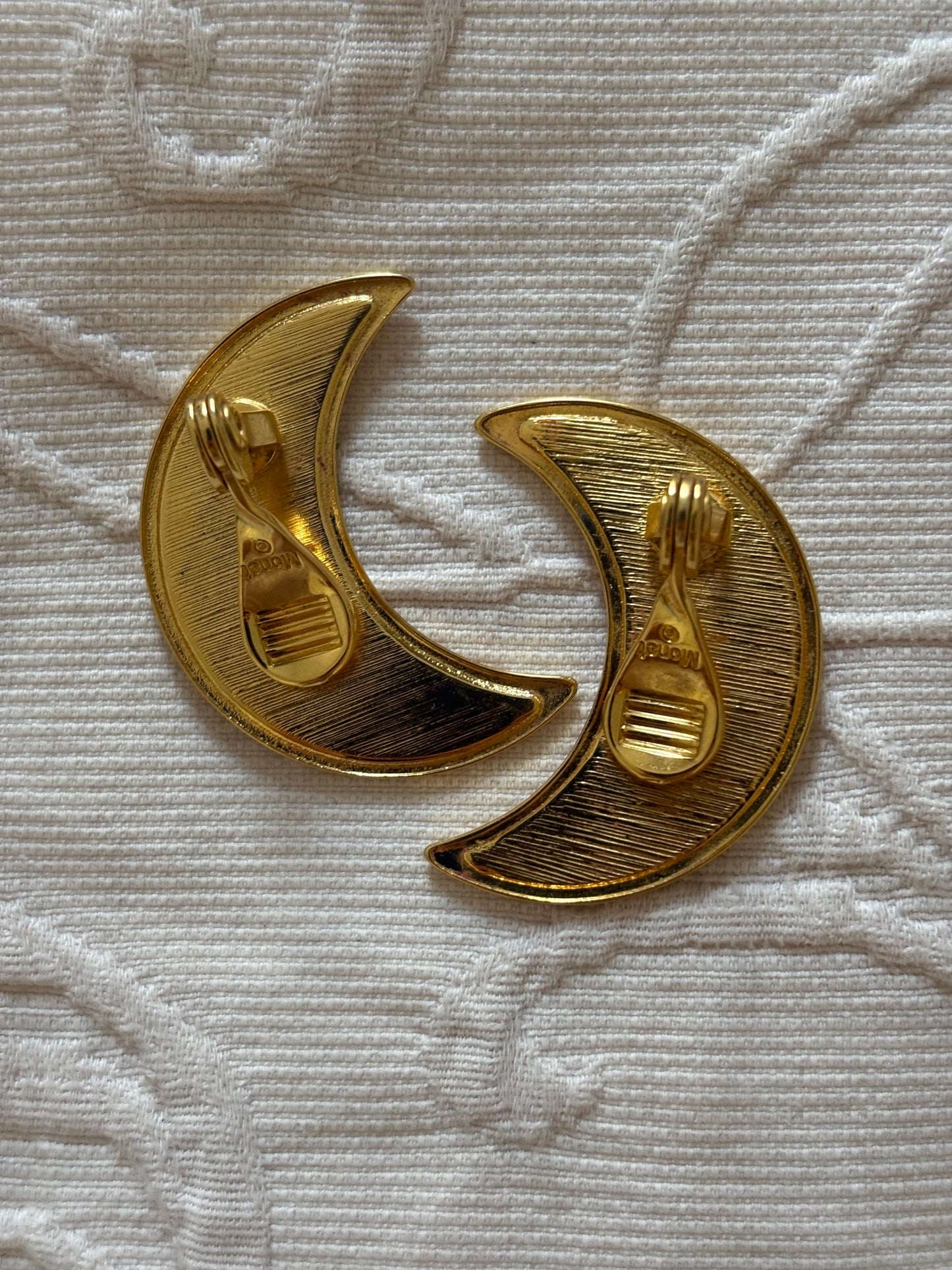 Clip-on earrings with milky enamel in the shape of a large moon