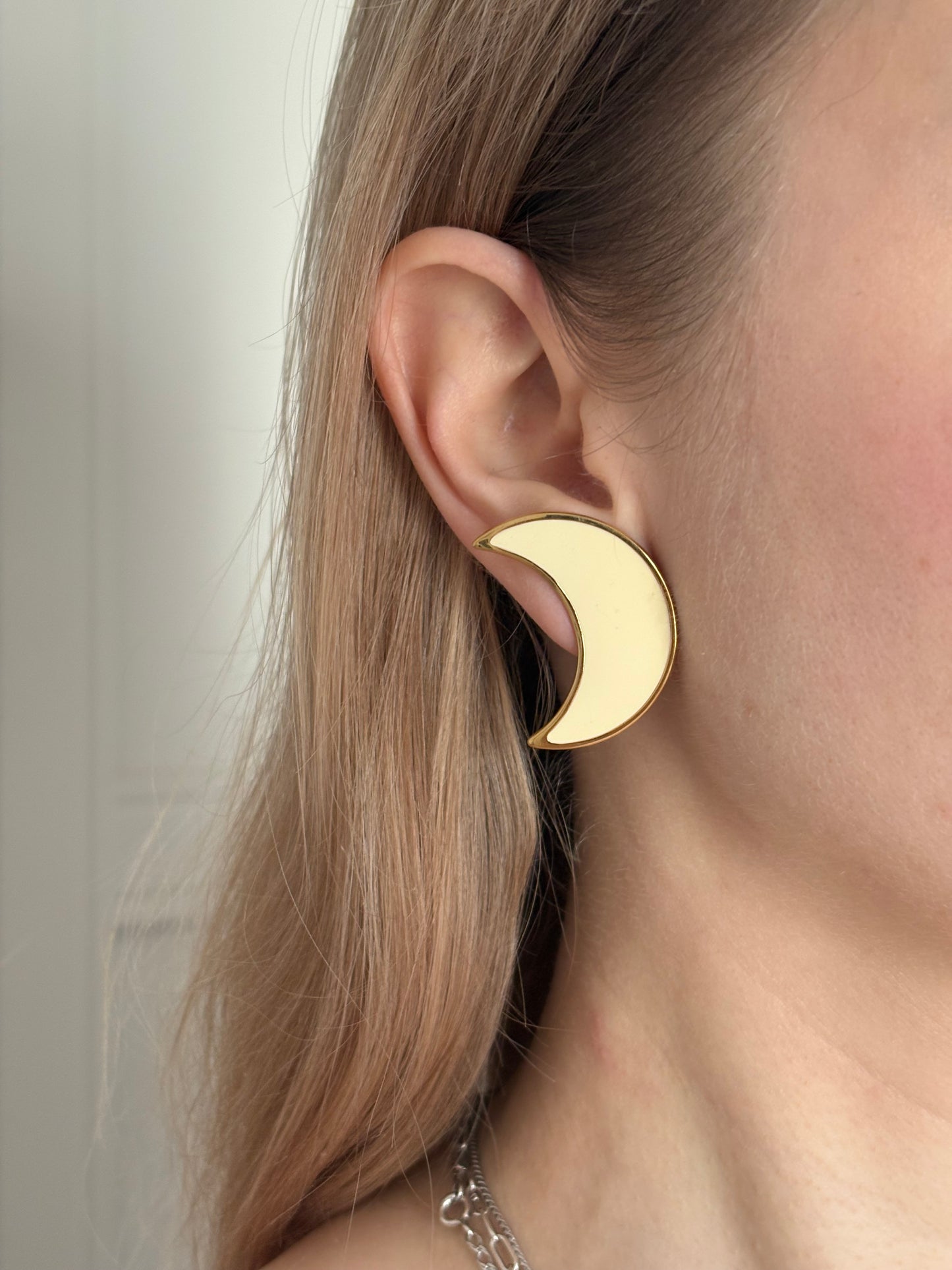 Clip-on earrings with milky enamel in the shape of a large moon