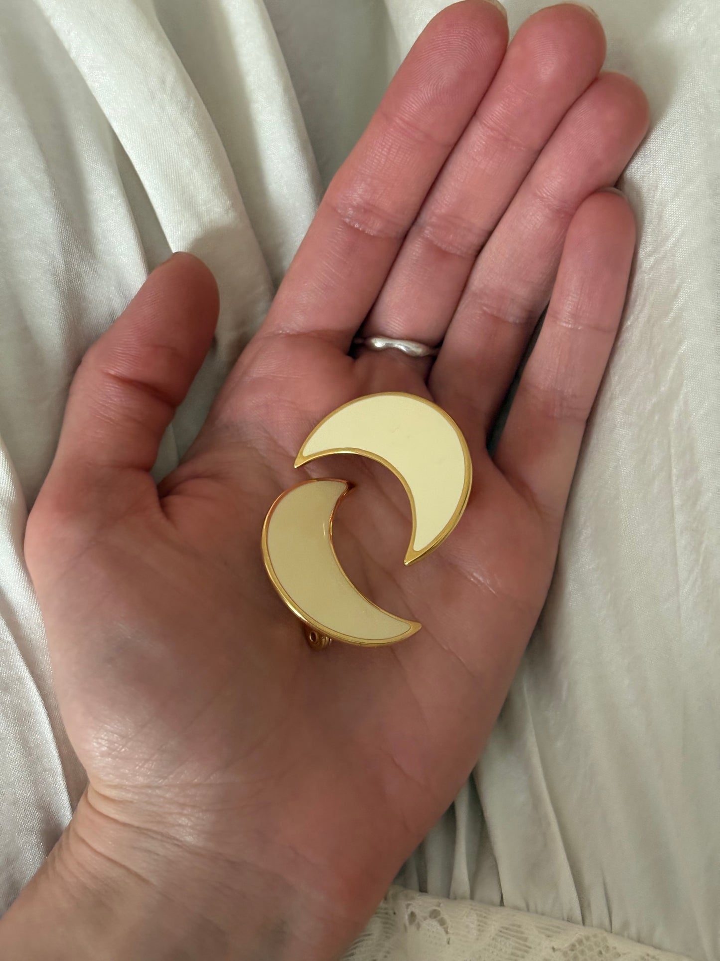 Clip-on earrings with milky enamel in the shape of a large moon