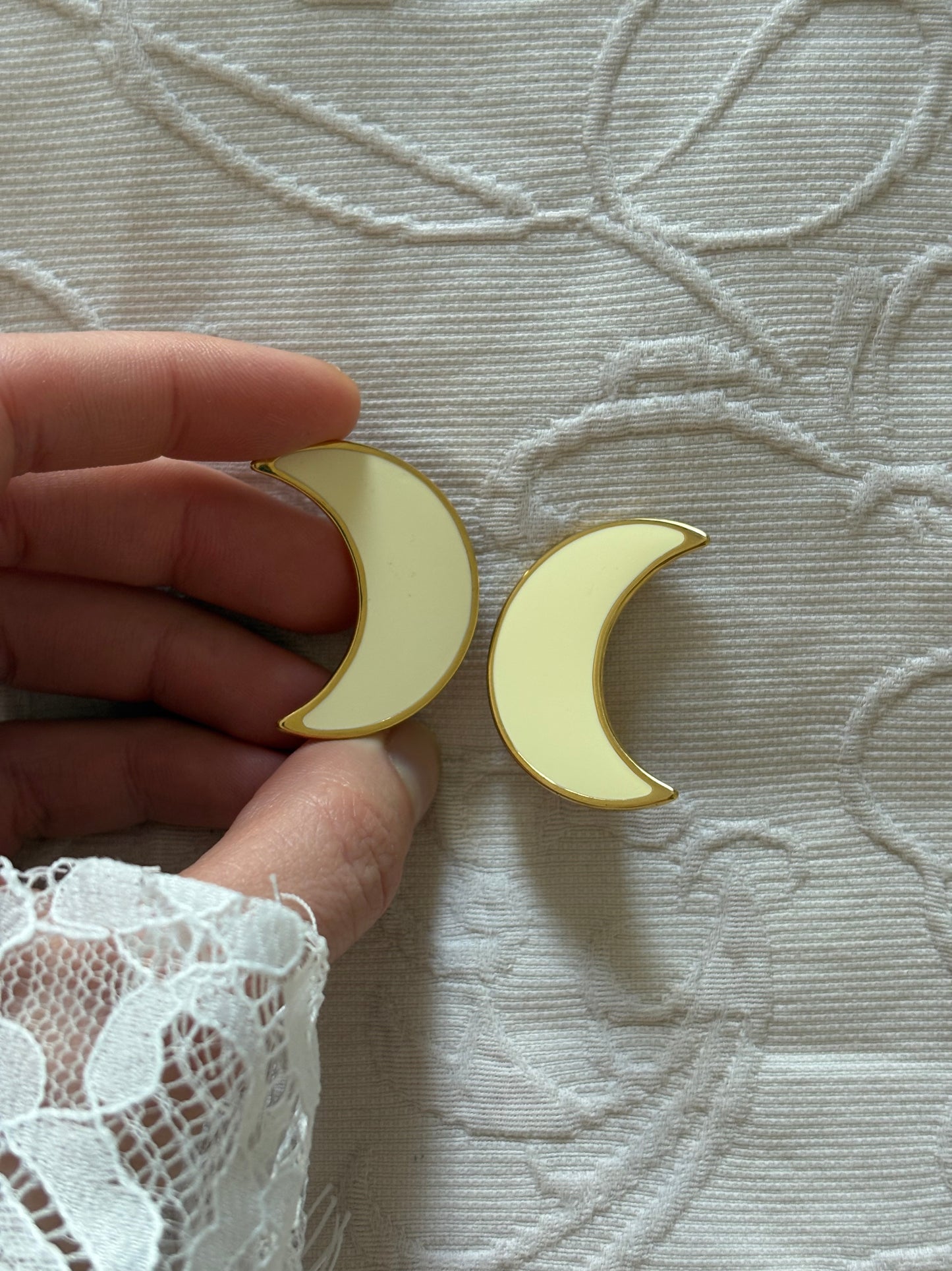 Clip-on earrings with milky enamel in the shape of a large moon