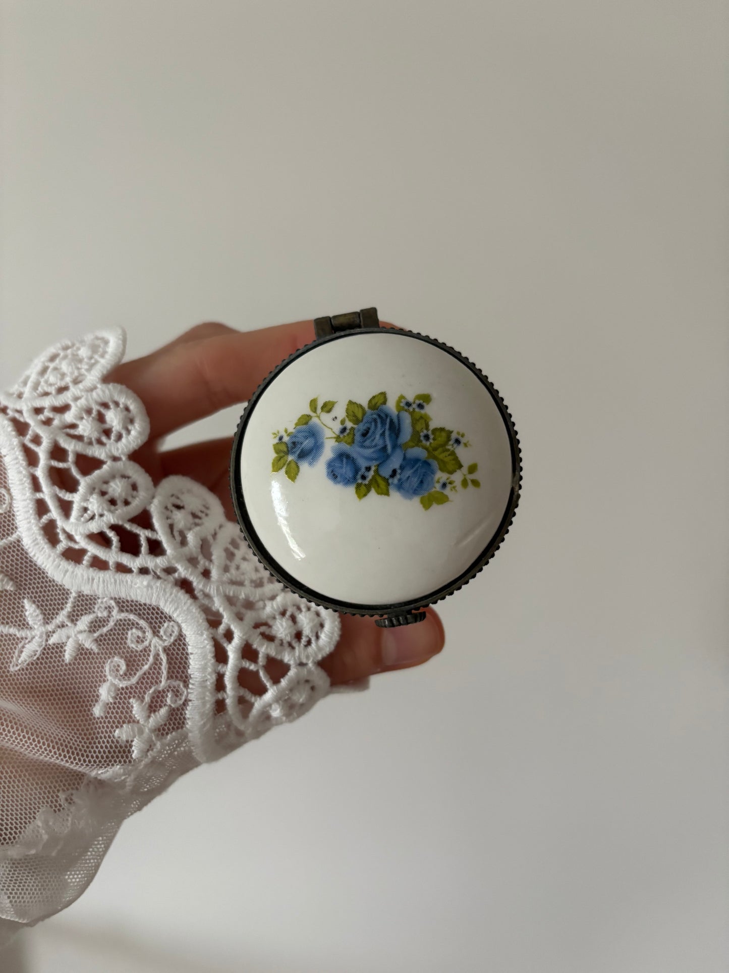 Round porcelain trinket box with blue roses